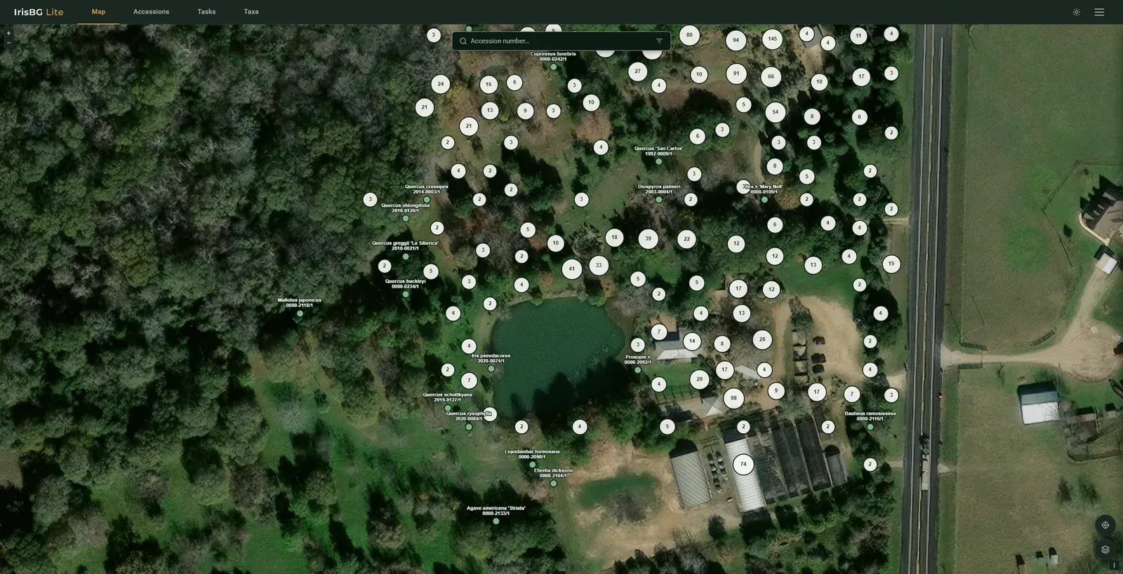 IrisBG Lite map view on a computer: satellite imagery of a garden with accessions grouped into numbered clusters, labelled plants, and an accession number search at the top.